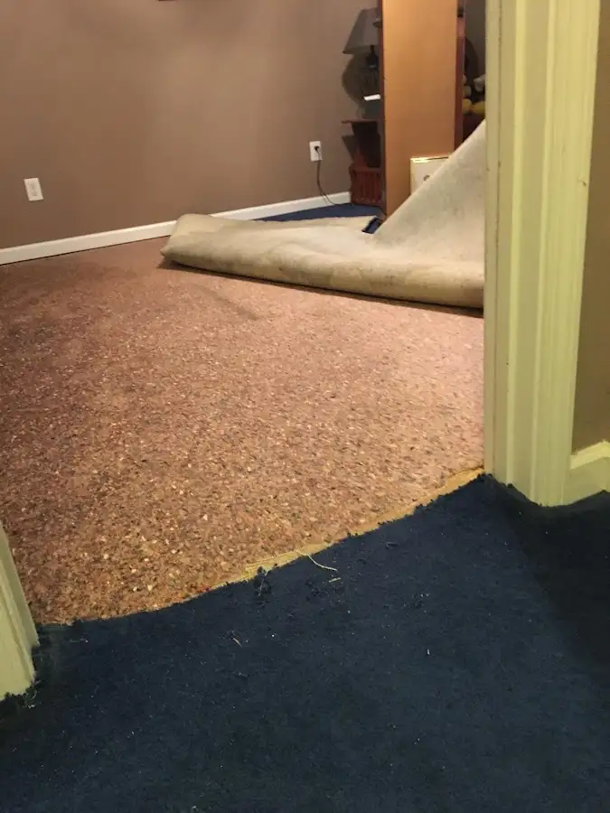Carpet pad removal revealing water damage during Water Mitigation Services in St. Gabriel